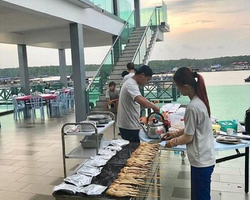 Seafood BBQ skewers grilling on the waterfront deck at TAN Castle
